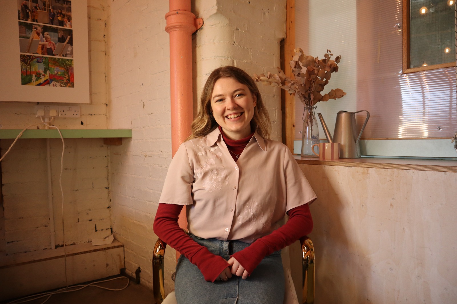 Esme Michaela, sitting in an office chair