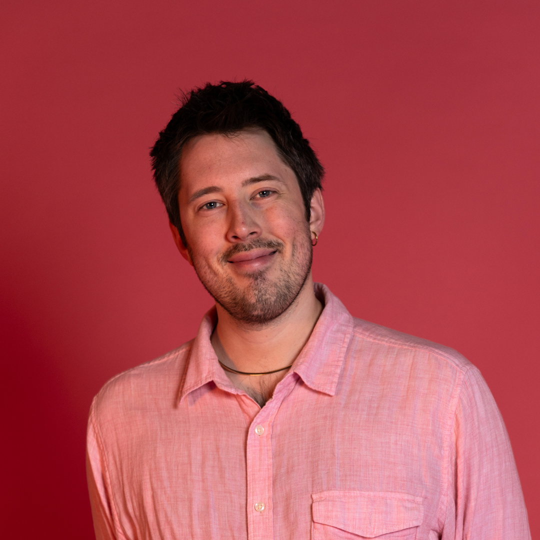 Jo Coats Headshot. Pink button-down